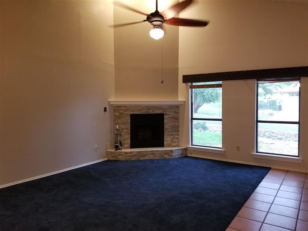 103 Dawn, Unit 4 Horseshoe Bay, TX 78657 - Photo 2 of 6 an empty room with windows and fireplace