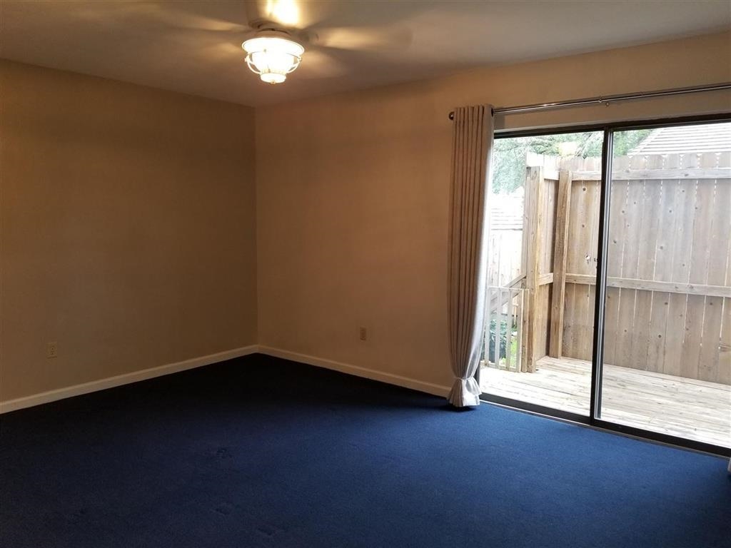 103 Dawn, Unit 4 Horseshoe Bay, TX 78657 - Photo 4 of 6 wooden floor in an empty room with a window
