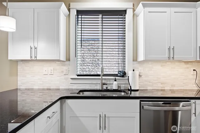 a kitchen with stainless steel appliances a refrigerator sink and microwave