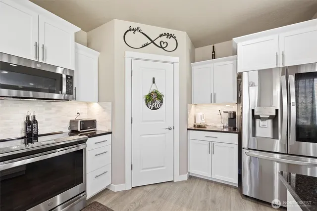 a kitchen with granite countertop a stove and a microwave