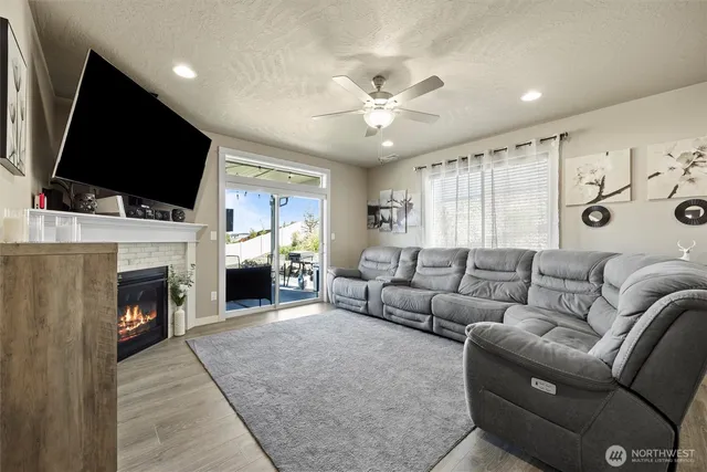 a living room with fireplace furniture and a flat screen tv