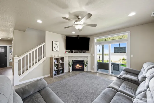 a living room with furniture a flat screen tv and a fireplace