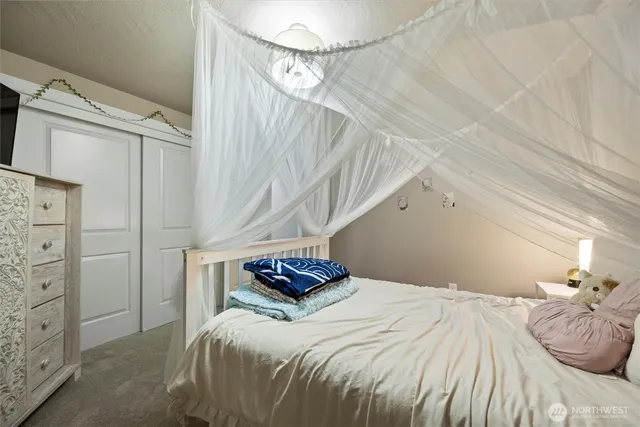 a bedroom with furniture and a flat screen tv