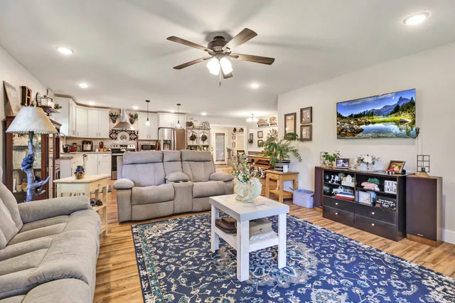 a living room with furniture and kitchen view