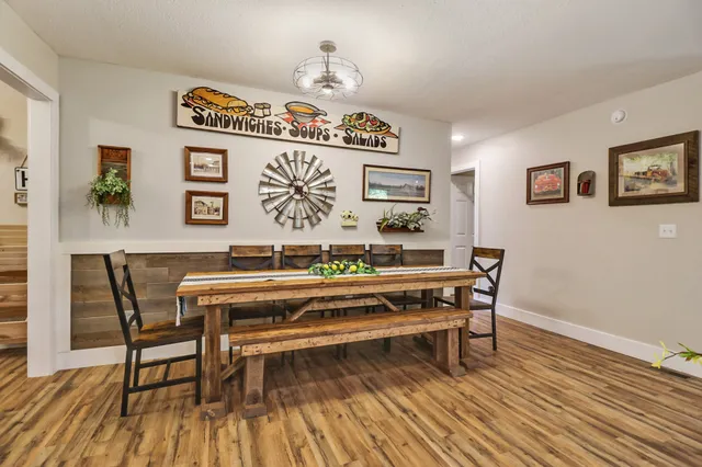 a view of a work space with furniture and wooden floor