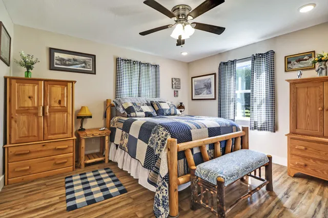 a spacious bedroom with a bed and a chandelier