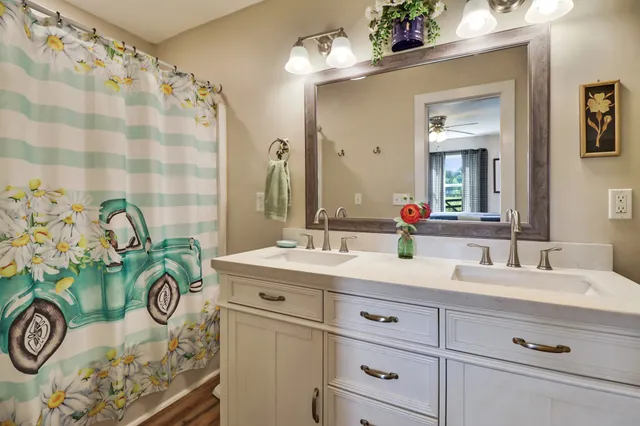 a bathroom with a granite countertop bathtub sink vanity and mirror
