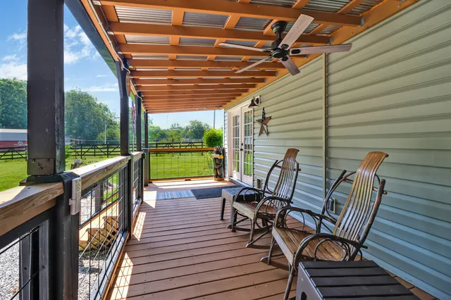 a view of a chairs and table in the balcony