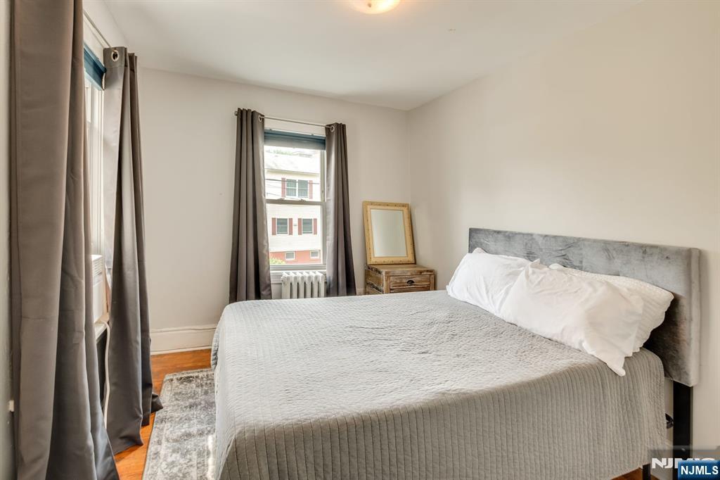 278 High Street Hackensack, NJ 07601 - Photo 8 of 16 a bedroom with a bed and a window