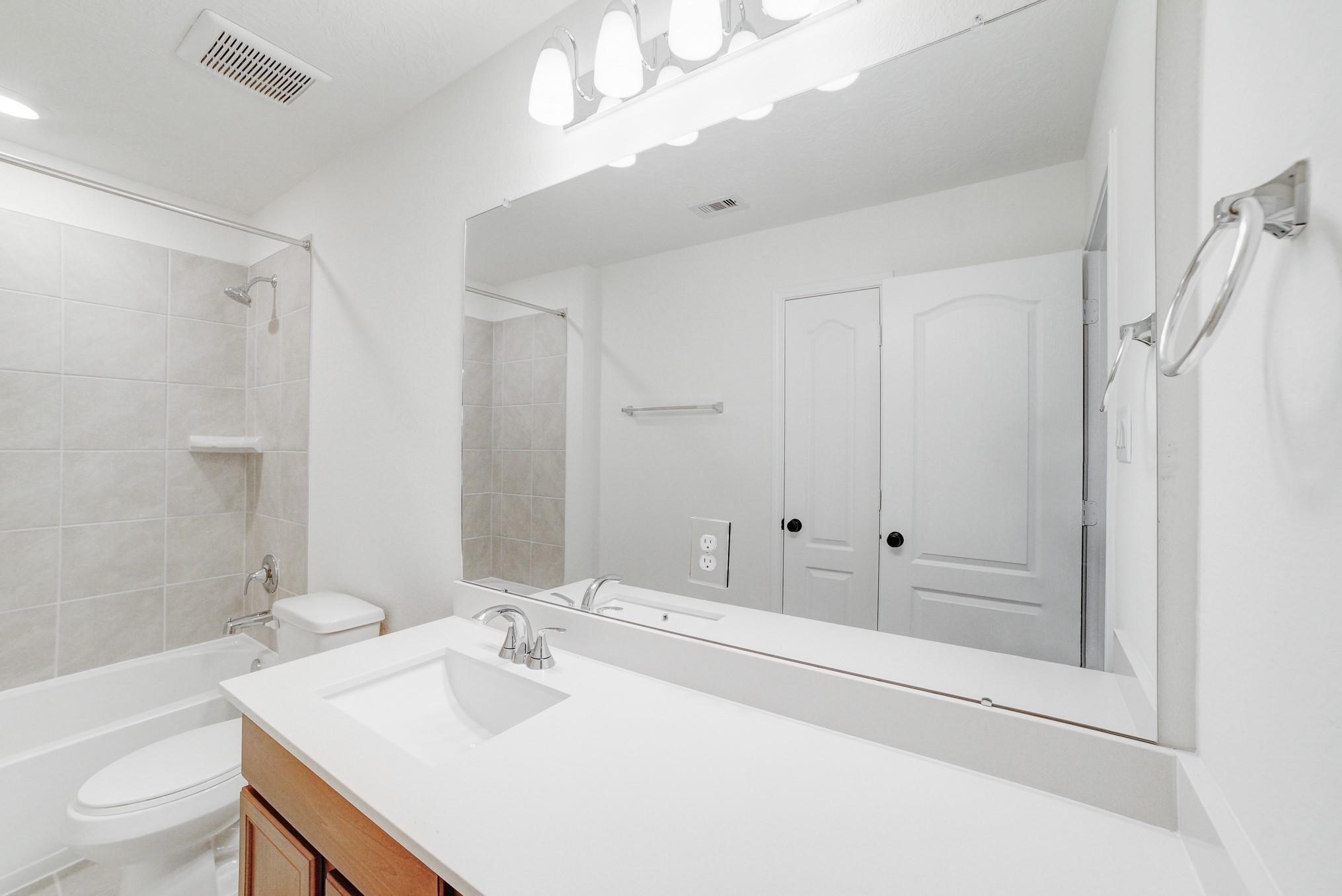 9307 Central Place Magnolia, TX 77354 - Photo 12 of 21 a bathroom with a sink a toilet and shower