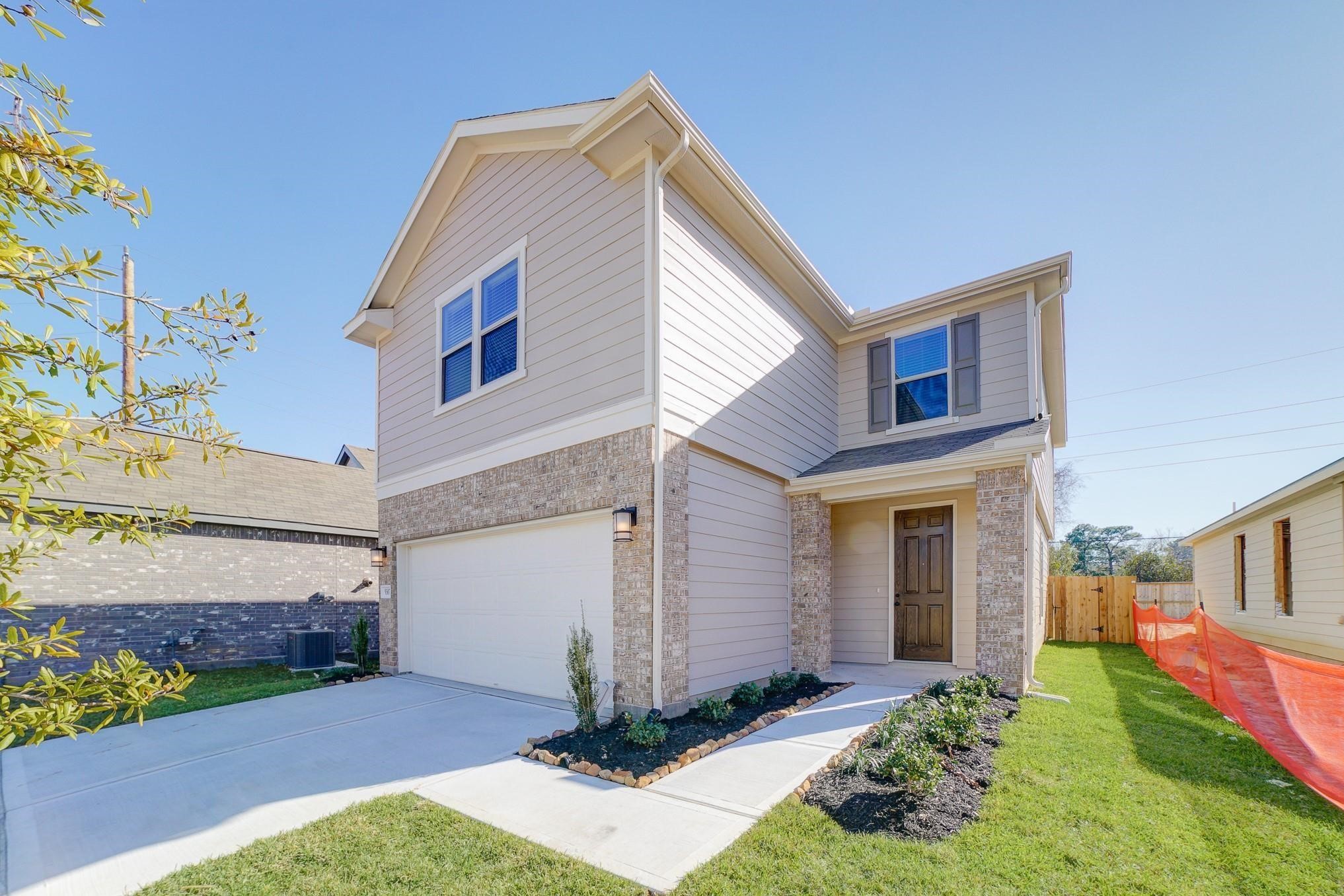 9307 Central Place Magnolia, TX 77354 - Photo 19 of 21 a front view of a house with a yard