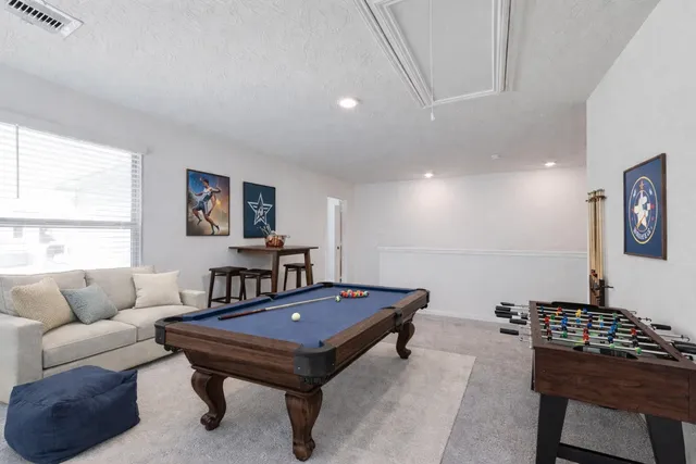 a living room with furniture a rug and a window
