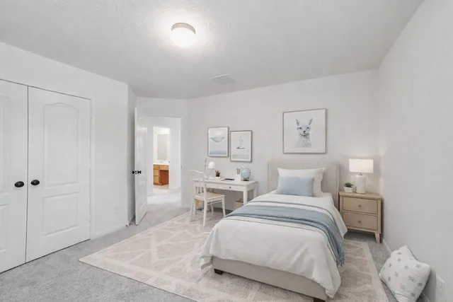 a bedroom with a bed and a lamp