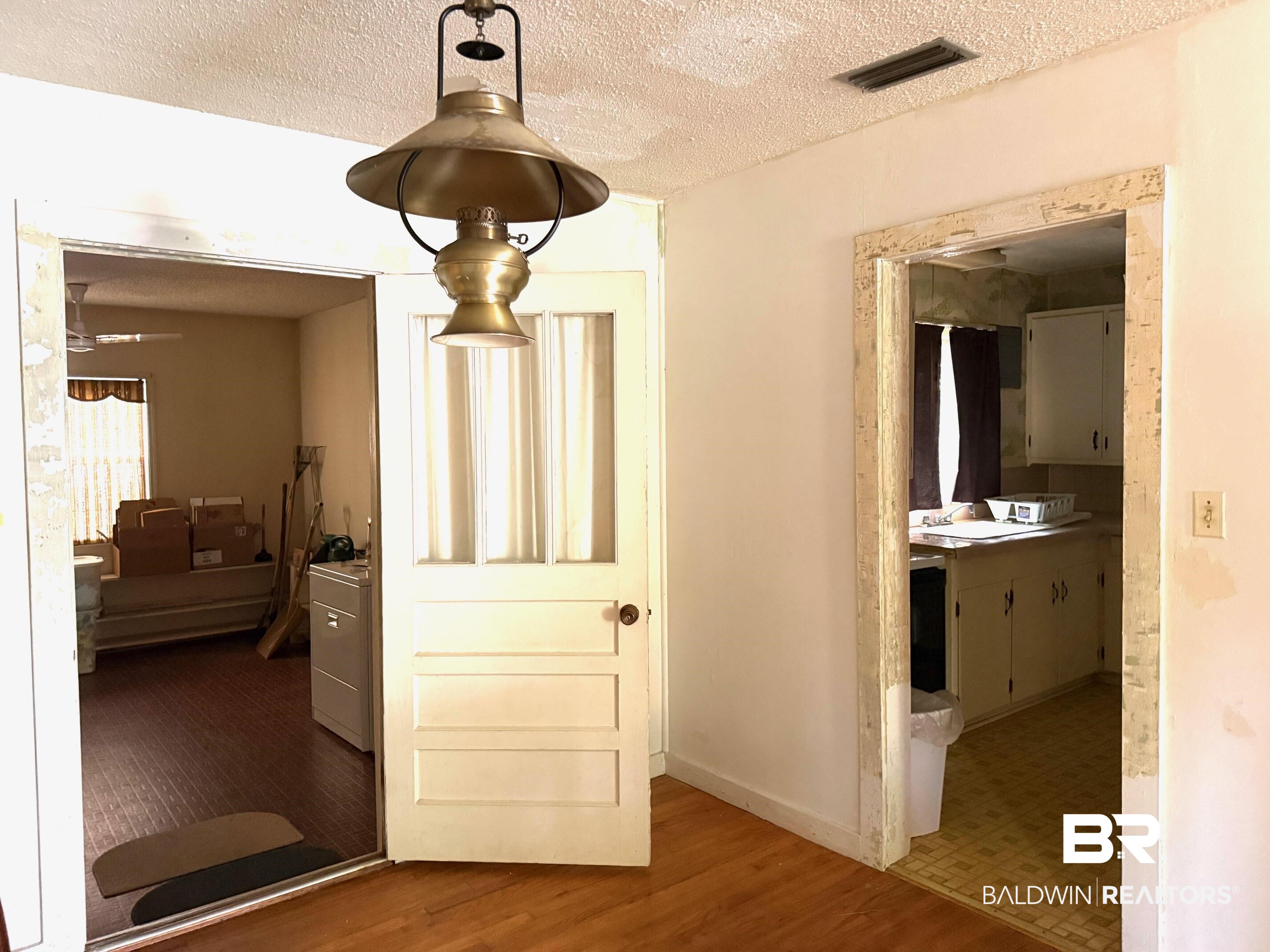 156 Pier Avenue Fairhope, AL 36532 - Photo 24 of 41 Detailed view of a textured ceiling and wood finished floors