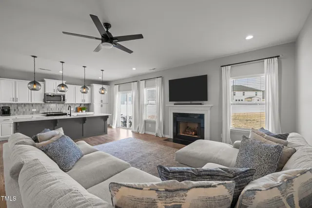 a living room with furniture a flat screen tv and a fireplace