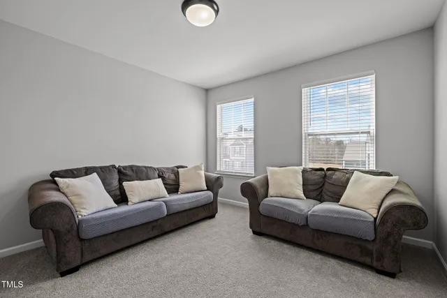 a view of a room with a hallway and a room with wooden floor