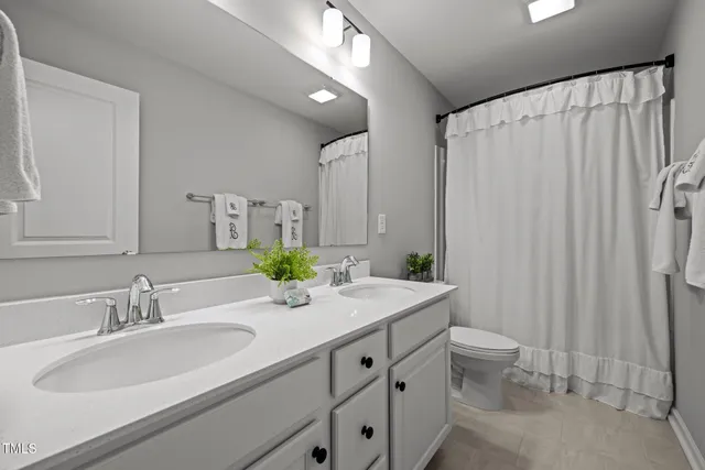 a view of an empty room with window and closet area