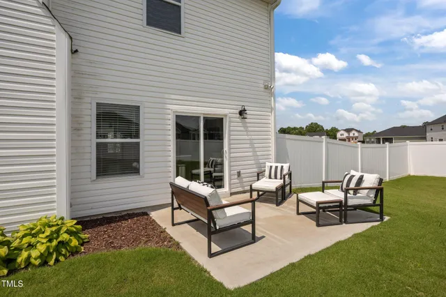 a view of a house with backyard sitting area and garden