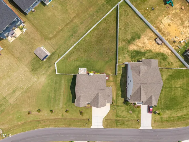 an aerial view of a swimming pool with outdoor seating