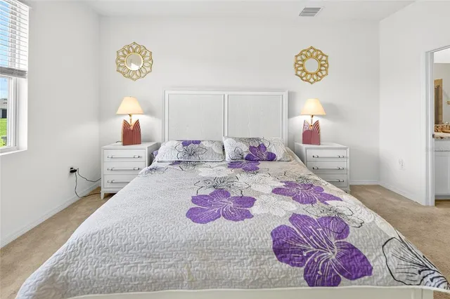 a bedroom with a bed and a lamp on table