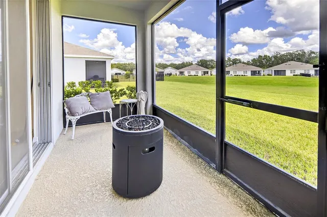 a view of a floor to ceiling window and an ocean view
