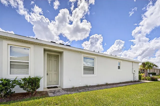 a view of a house with a yard and garage