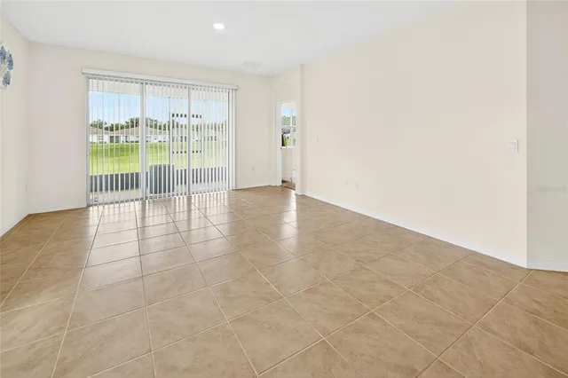 an empty room with floor to ceiling window and an empty room