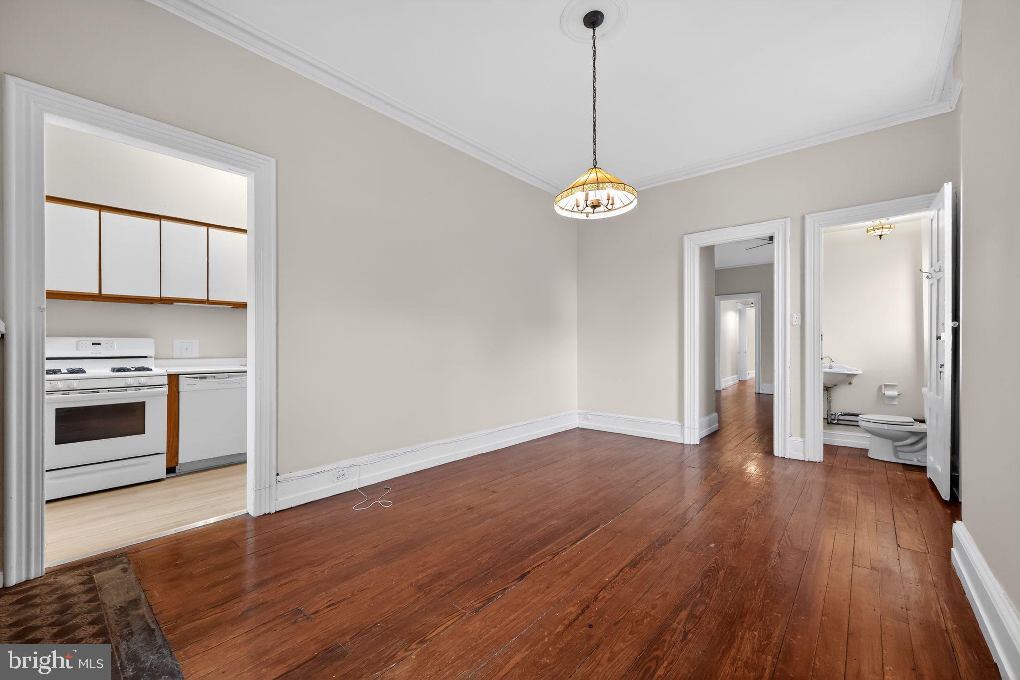 2117 Spruce Street, Unit 3 Philadelphia, PA 19103 - Photo 11 of 14 a view of an empty room with a stove and wooden floor