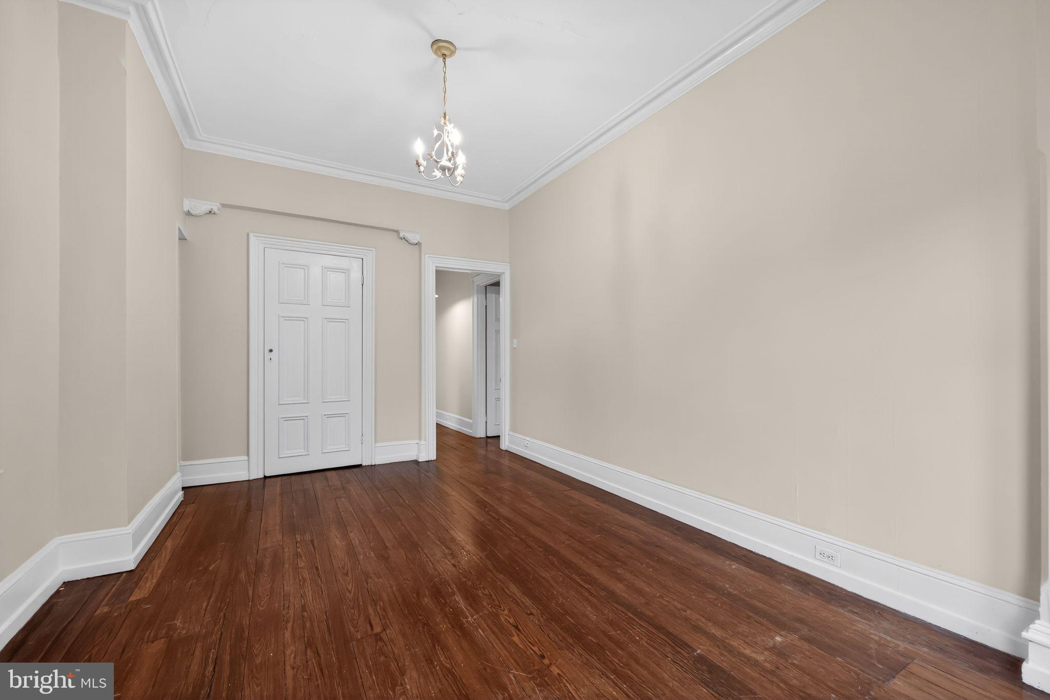 2117 Spruce Street, Unit 3 Philadelphia, PA 19103 - Photo 12 of 14 a view of an empty room with wooden floor and a window