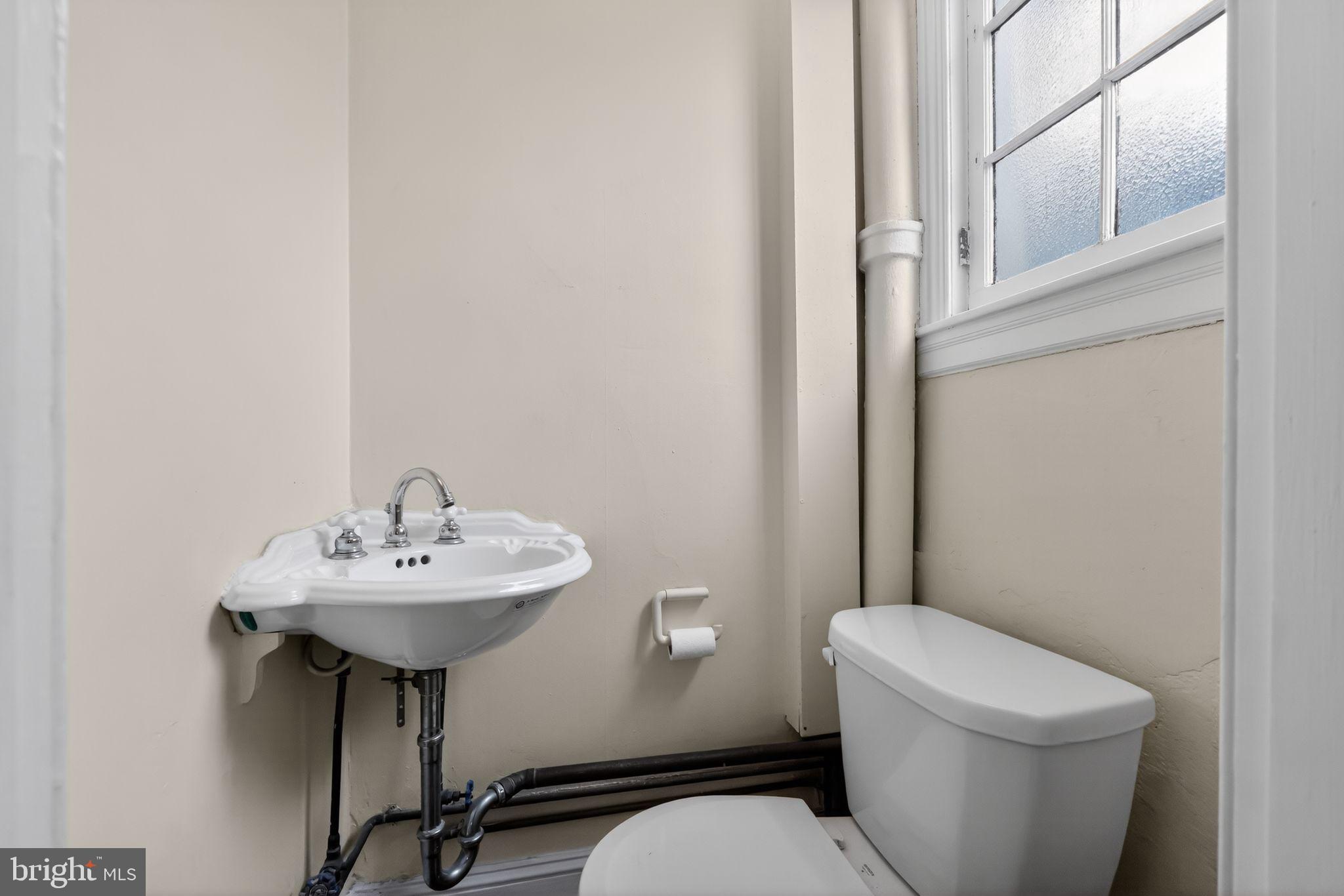 2117 Spruce Street, Unit 3 Philadelphia, PA 19103 - Photo 14 of 14 a bathroom with a sink a mirror and a toilet