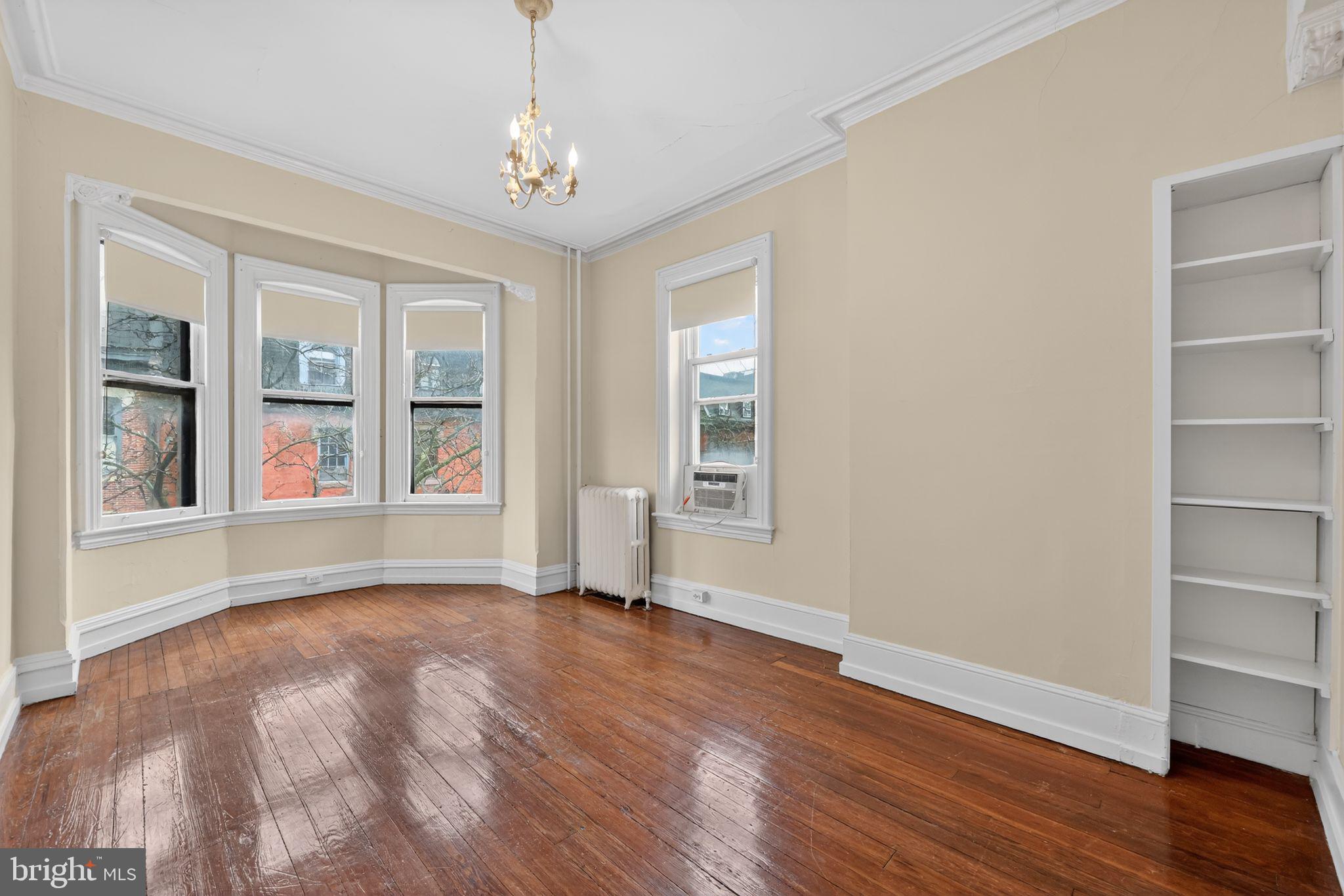 2117 Spruce Street, Unit 3 Philadelphia, PA 19103 - Photo 2 of 14 a view of an empty room with window and wooden floor