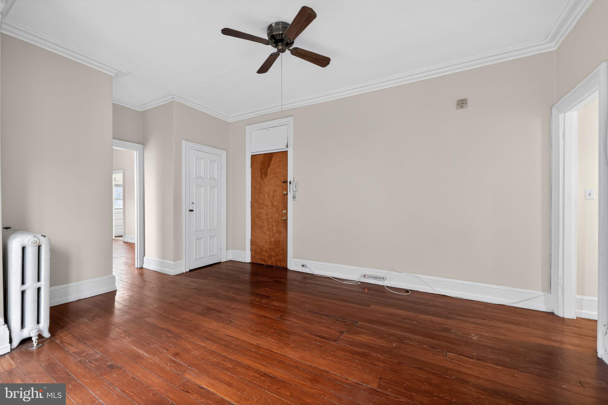 2117 Spruce Street, Unit 3 Philadelphia, PA 19103 - Photo 5 of 14 a view of an empty room with wooden floor and a window