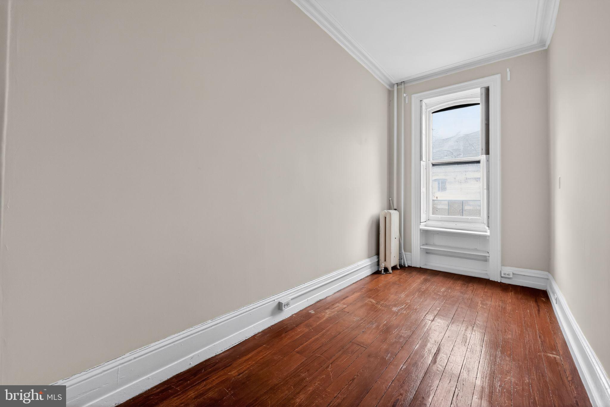 2117 Spruce Street, Unit 3 Philadelphia, PA 19103 - Photo 8 of 14 a view of an empty room with wooden and a window