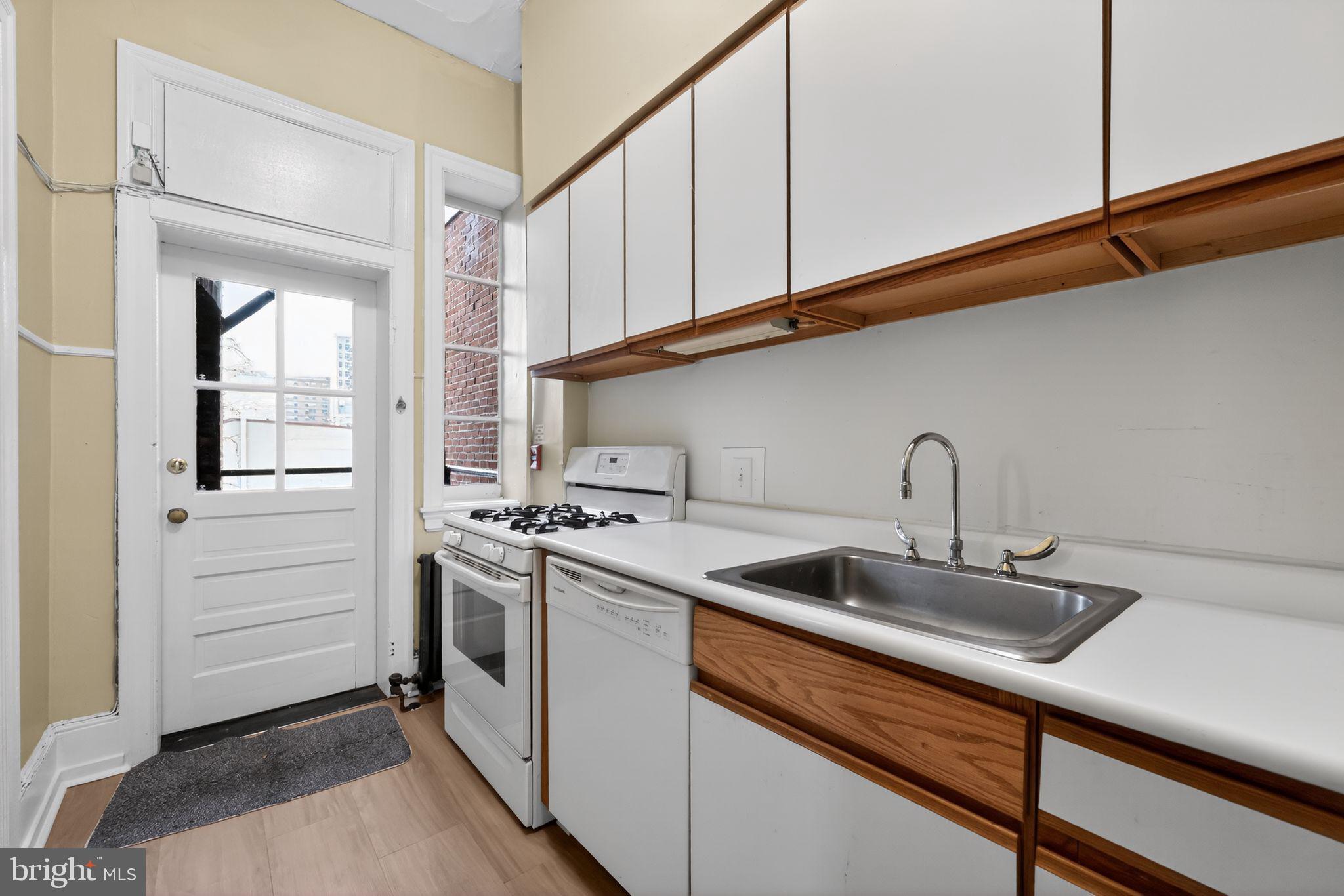 2117 Spruce Street, Unit 3 Philadelphia, PA 19103 - Photo 9 of 14 a kitchen that has a sink and a stove