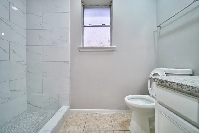a bathroom with a toilet a sink and bath tub