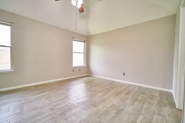 wooden floor in an empty room with a window