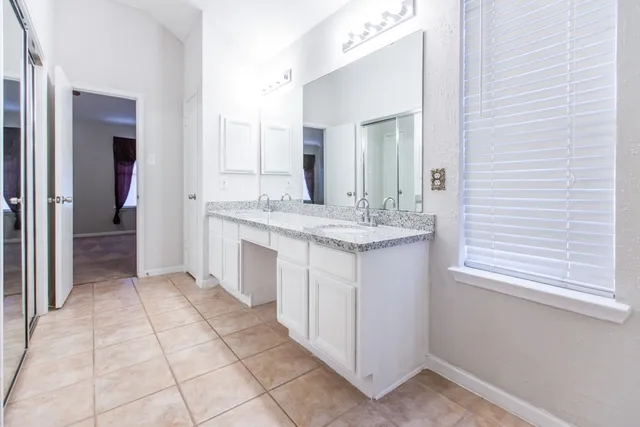 a bathroom with a sink vanity and a mirror