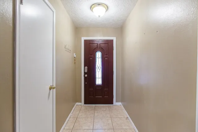 an entryway door with a hallway in the house