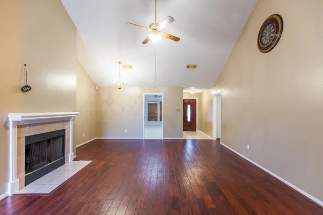 wooden floor in an empty room with a fireplace