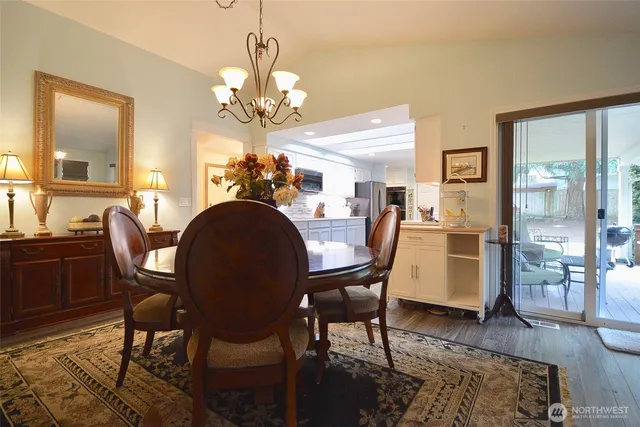 a bedroom with a bed chair and wooden floor