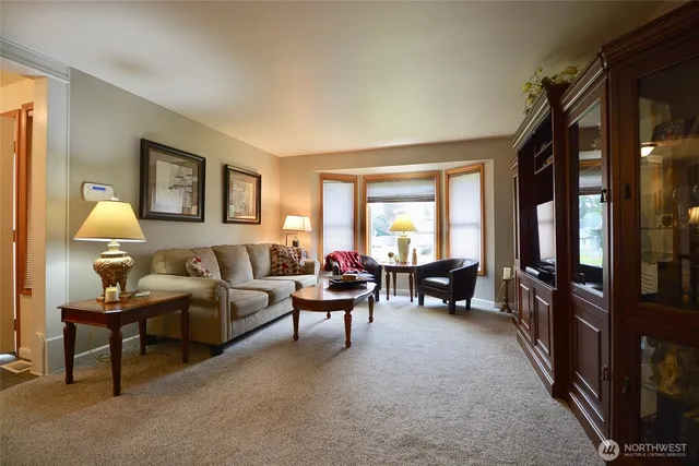 a kitchen with stainless steel appliances granite countertop a sink a stove and a wooden floors