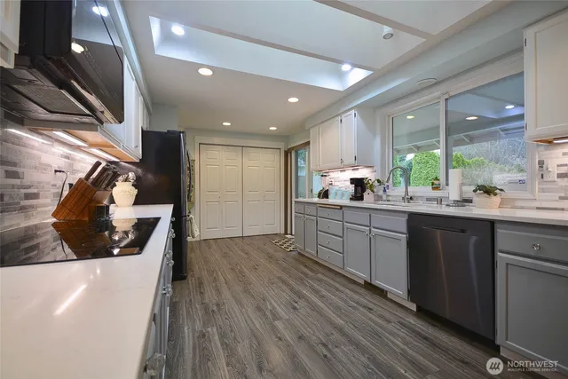 a living room with furniture a dining table and a chandelier