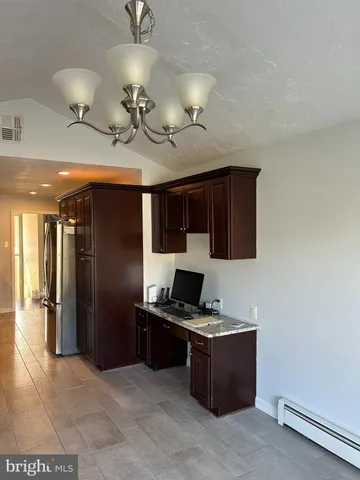 a kitchen with stainless steel appliances a refrigerator and a stove