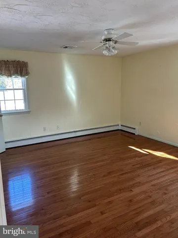 a view of a room with wooden floor
