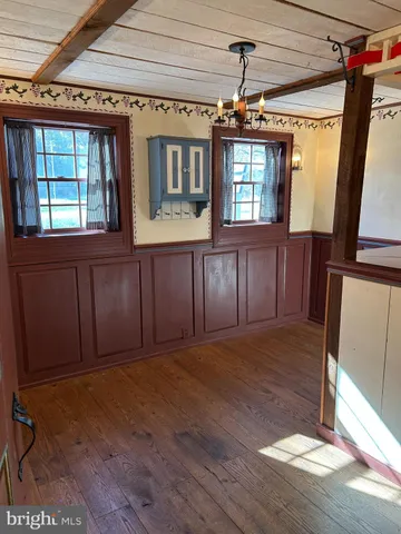 a view of a door and wooden floor in a room