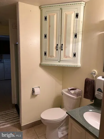 a bathroom with a toilet a sink and a mirror