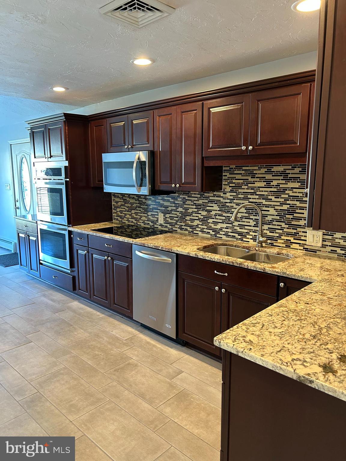 95 Table Rock Road Gettysburg, PA 17325 - Photo 8 of 31 a kitchen with stainless steel appliances granite countertop wooden cabinets sink and stove