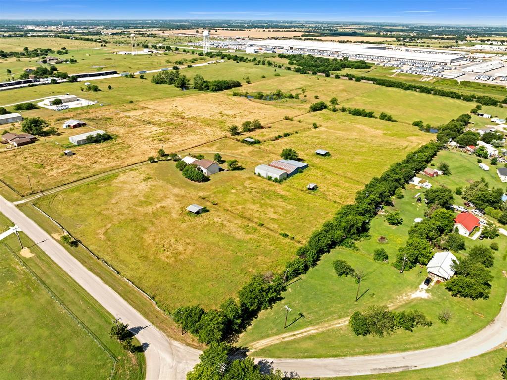 1795 Melton Road Sanger, TX 76266 - Photo 8 of 17 Expansive rural property featuring a mix of open fields, several residential structures, and various outbuildings