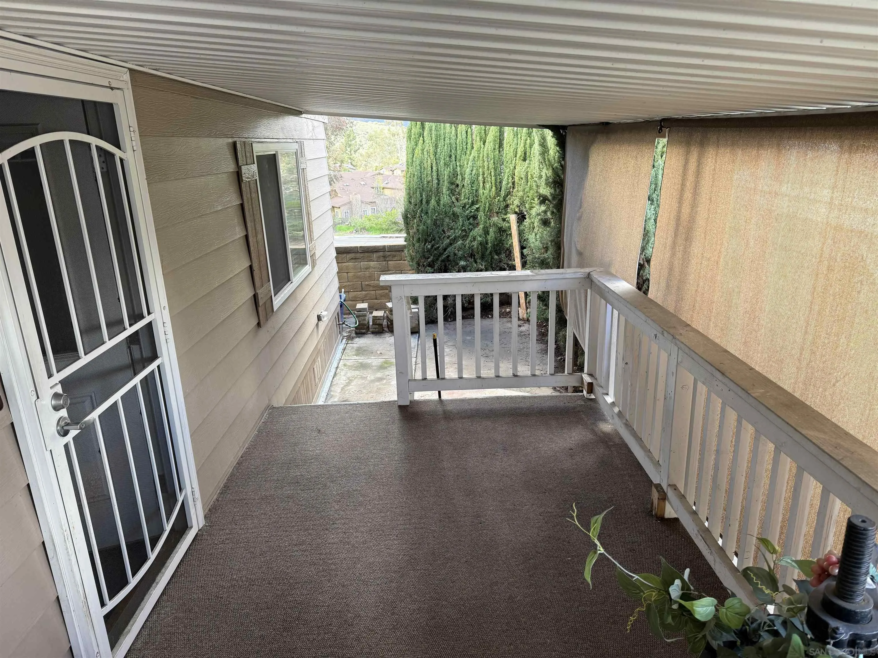 7467 Mission Gorge Road, Unit SPC 19 Santee, CA 92071 - Photo 16 of 20 a view of a porch with wooden floor and stairs