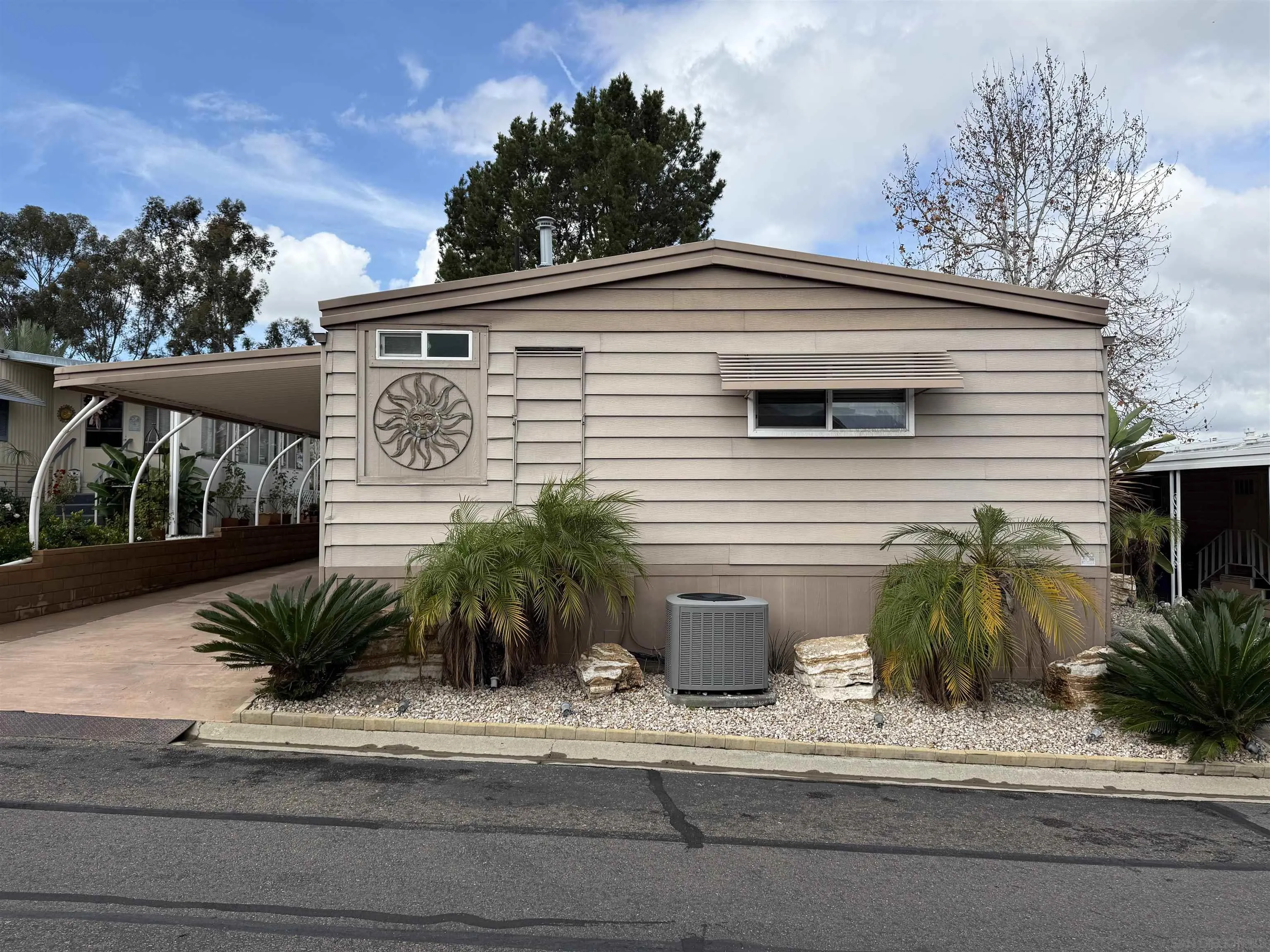 7467 Mission Gorge Road, Unit SPC 19 Santee, CA 92071 - Photo 2 of 20 a palm tree sitting in front of a house